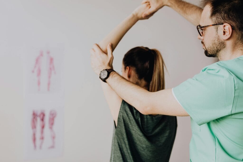 A StretchMasters therapist assists a patient with a stretch routine.