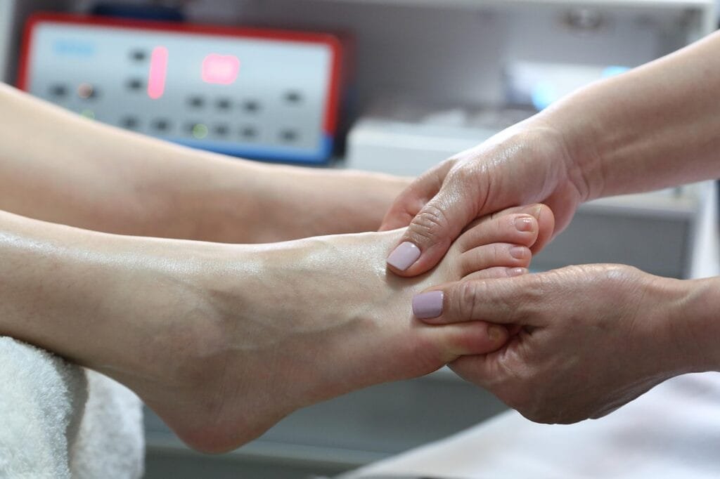 StretchMasters® UK Physiotherapist helps a patient with a gentle assisted stretch