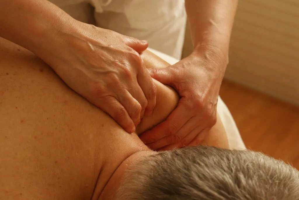StretchMasters® UK Physiotherapist helps a patient with a gentle assisted stretch