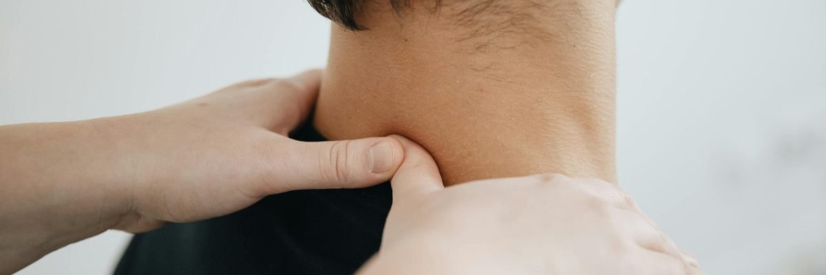 pexels-photo-20860604-20860604 Close-up of a physiotherapist providing neck massage for pain relief in a clinic setting.