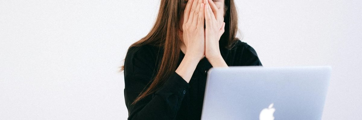 pexels-photo-4226215-4226215 Woman feeling stressed and overwhelmed at her desk while working remotely on a laptop.